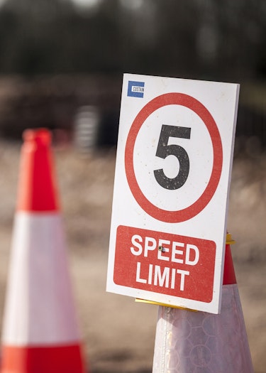 Close up of 5 mile per hour speed limit sign on traffic cone
